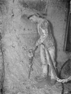 The completion of the pilot Dartford Tunnel. A miner works around a tunneling The completion of the pilot Dartford Tunnel. A miner works around a tunneling