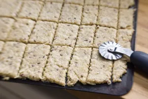 Cookie dough rolled out on baking sheet cut with pastry cutter, before going into oven credit Cookie dough rolled out on baking sheet cut with pastry cutter, before going into oven credit