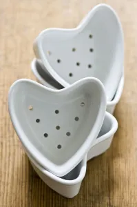 Four couer a la creme moulds stacked on old wooden surface credit: Marie-Louise Four couer a la creme moulds stacked on old wooden surface credit: Marie-Louise