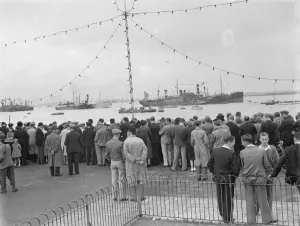 Crowds look at the collection of water vessels on the Thames which are part of the Crowds look at the collection of water vessels on the Thames which are part of the