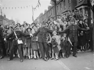 Crowds stand at the side of the road and cheer for the Duchess of Kent Crowds stand at the side of the road and cheer for the Duchess of Kent