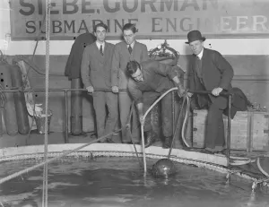 Demonstration of divers at work at Siebe. Gorman and Co s tanks at Westminster Demonstration of divers at work at Siebe. Gorman and Co s tanks at Westminster