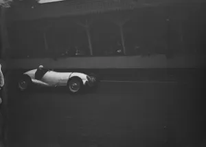 Dick Seaman driving at speed in his Mercedes Benz racing car, the Mercedes-Benz Dick Seaman driving at speed in his Mercedes Benz racing car, the Mercedes-Benz