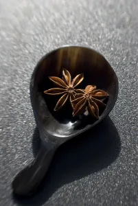 Dried Star anise fruits in small bowl. Also known as star aniseed, badiane or Chinese Dried Star anise fruits in small bowl. Also known as star aniseed, badiane or Chinese