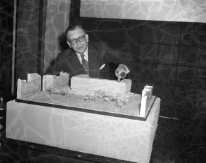 Eero Saarinen, the famous Finnish architect points out features in his model of his Eero Saarinen, the famous Finnish architect points out features in his model of his