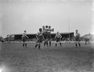 Footballers at Dartford. Players compete for the ball in the air Footballers at Dartford. Players compete for the ball in the air