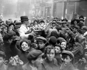 Free distribution of buns to poor children in Lane by a local butcher. 31 March 1923 Free distribution of buns to poor children in Lane by a local butcher. 31 March 1923