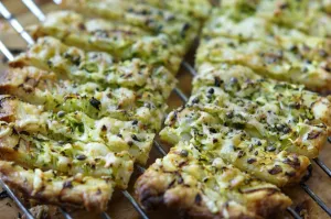 Freshly baked cheese straws cooling on rack, made with grated courgette and grated Freshly baked cheese straws cooling on rack, made with grated courgette and grated