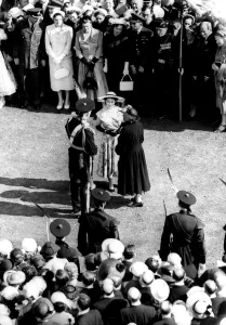 HM The Queen wore a patterned blue silk dress, and wide-brimmed blue hat, as she HM The Queen wore a patterned blue silk dress, and wide-brimmed blue hat, as she