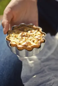 Home made quiche in its tin held in the hand credit: Marie-Louise Avery / thePictureKitchen Home made quiche in its tin held in the hand credit: Marie-Louise Avery / thePictureKitchen