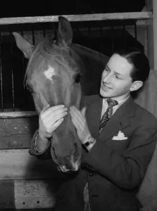 Horse in its stable with its trainer before a show at the Olympia Circus, London Horse in its stable with its trainer before a show at the Olympia Circus, London