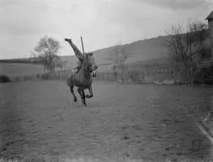 Horse trick riding in Eynsford, Kent. Mr Jorganoff performing a side stand whilst Horse trick riding in Eynsford, Kent. Mr Jorganoff performing a side stand whilst