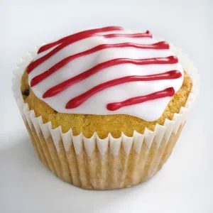 Iced cupcake with red stripes on white icing credit: Marie-Louise Avery Iced cupcake with red stripes on white icing credit: Marie-Louise Avery