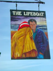 The Lifeboat: painted pub sign hanging outside a public house depicting a local crew The Lifeboat: painted pub sign hanging outside a public house depicting a local crew