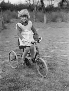 Little Ann Bowers playing on her tricycle with her tame jackdaw sitting on the handlebars Little Ann Bowers playing on her tricycle with her tame jackdaw sitting on the handlebars