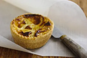 Little Quiche Lorraine on curled greaseproof paper with knife credit: Marie-Louise Little Quiche Lorraine on curled greaseproof paper with knife credit: Marie-Louise