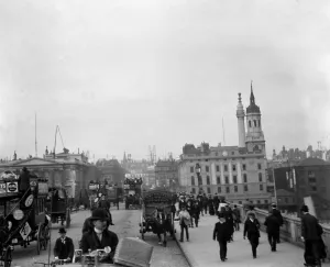 London street scene Pedestrians and horse drawn traffic making their way across London street scene Pedestrians and horse drawn traffic making their way across