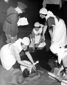 Major G T McKonkey RAMC questioning nurses of Kent 60 VAD during a War Office test Major G T McKonkey RAMC questioning nurses of Kent 60 VAD during a War Office test