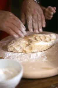Man kneading and rolling pastry with little girl helping - hands only shown credit Man kneading and rolling pastry with little girl helping - hands only shown credit