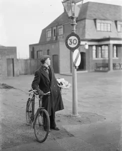 A man looking at a 30 miles per hour speed limit sign in Birchwood, Kent A man looking at a 30 miles per hour speed limit sign in Birchwood, Kent