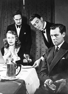 A man wants to impress his lady friend but two waiters produce the bill to the couple after dinner A man wants to impress his lady friend but two waiters produce the bill to the couple after dinner