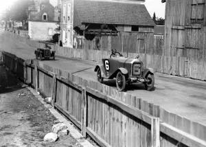 A Mathis car in 1923, a six-cylinder model, driving along a track A Mathis car in 1923, a six-cylinder model, driving along a track