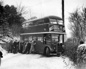 Ten men tried their hardest to push the bus straight again after it had skidded right Ten men tried their hardest to push the bus straight again after it had skidded right