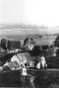A mother and her girls climb the steep hill at the back of their garden to fetch water A mother and her girls climb the steep hill at the back of their garden to fetch water