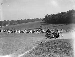 Motorcycling races at Brands Hatch. Two of the side car bikes jostle for position Motorcycling races at Brands Hatch. Two of the side car bikes jostle for position