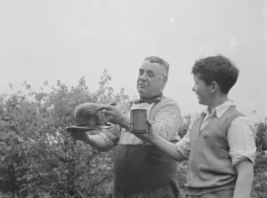 Mr Charlie Hever painting tar onto a bowler hat in Eynsford, Kent. 1937 Mr Charlie Hever painting tar onto a bowler hat in Eynsford, Kent. 1937