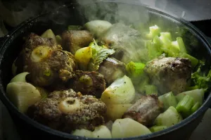 Oxtail casserole with onions and celery being started on top of stove before being Oxtail casserole with onions and celery being started on top of stove before being