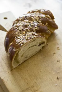 Piece of sweet, yeast bread with almonds and almond paste on wooden board credit Piece of sweet, yeast bread with almonds and almond paste on wooden board credit