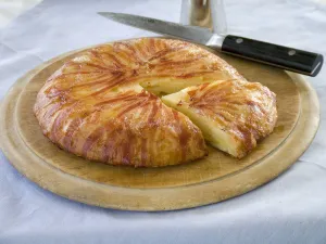 Potato galette wrapped in bacon on wooden board with knife credit: Marie-Louise Potato galette wrapped in bacon on wooden board with knife credit: Marie-Louise