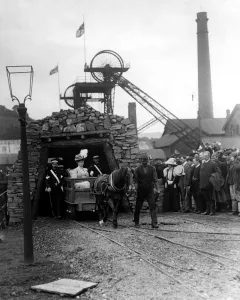 Queen Mary is led out of a coal mine by a miner and pit pony during a Royal visit Queen Mary is led out of a coal mine by a miner and pit pony during a Royal visit