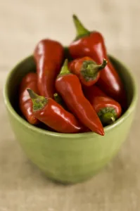 Red hot chilli peppers in green bowl credit: Marie-Louise Avery / thePictureKitchen Red hot chilli peppers in green bowl credit: Marie-Louise Avery / thePictureKitchen