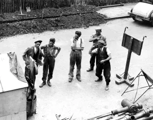 The road workers take a break from their manual labour for a cigarette and a game The road workers take a break from their manual labour for a cigarette and a game