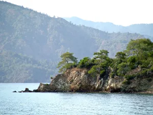Rocky promontary with mountain backdrop on south Turkish coast near Fethiye Rocky promontary with mountain backdrop on south Turkish coast near Fethiye