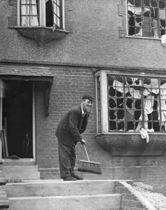 Schoolboy sweeping debris after his Gravesend home in Kent had been damaged by a Schoolboy sweeping debris after his Gravesend home in Kent had been damaged by a