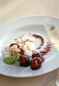 Spectacular, dessert of meringue with vanilla ice cream, cherry coulis and fresh Spectacular, dessert of meringue with vanilla ice cream, cherry coulis and fresh