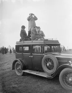 Spectators climb on to the roof of their car to get a good view of the R A Woolwich Spectators climb on to the roof of their car to get a good view of the R A Woolwich