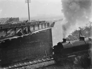 Steam engine passing by the building work being carried out for the widening of the Steam engine passing by the building work being carried out for the widening of the