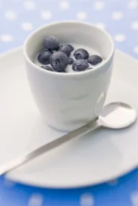 Summer breakfast of whole fresh blueberries in little bowl with cold milk credit Summer breakfast of whole fresh blueberries in little bowl with cold milk credit