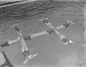 A synchronized swimming group perform a floating display at the opening for the new A synchronized swimming group perform a floating display at the opening for the new