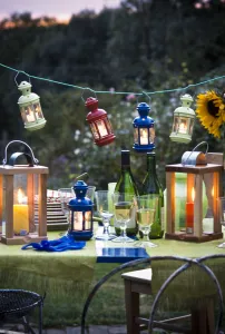 Table laid for a party outside on a summer evening, glasses of white wine with wine Table laid for a party outside on a summer evening, glasses of white wine with wine