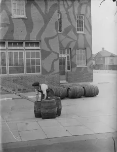 Taking in a barrel delivery outside The Northover, a camouflaged public house in Taking in a barrel delivery outside The Northover, a camouflaged public house in