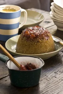 Traditional steamed sponge pudding with walnits and rhubarb compote and custard Traditional steamed sponge pudding with walnits and rhubarb compote and custard