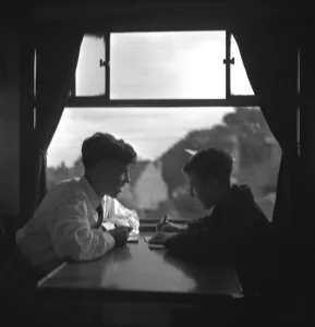 Trainspotters Club outing Two young trainspotters plan their day in the railway carriage Trainspotters Club outing Two young trainspotters plan their day in the railway carriage