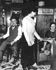 A waitress serves a booth at Flanagans restaurant near the Victoria and Albert Museum A waitress serves a booth at Flanagans restaurant near the Victoria and Albert Museum