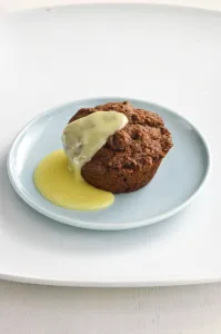 Warm chocolate muffin served as a dessert with custard sauce credit: Marie-Louise Warm chocolate muffin served as a dessert with custard sauce credit: Marie-Louise