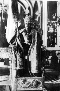 Wearing the crown specially made for his own coronation and holding his Royal Standard Wearing the crown specially made for his own coronation and holding his Royal Standard